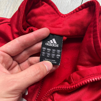AC Milan x Dolce &amp; Gabbana 2009/10 Track Jacket is a black and red junior football track jacket with asymetrical black and red pattern. The chest features AC Milan and Adidas logos on one side, and a D&amp;G Dolce &amp; Gabbana Junior logo on the left. Made with Climacool technology, it is designed for youth performance wear.