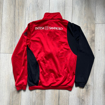 AC Milan x Dolce &amp; Gabbana 2009/10 Track Jacket is a black and red junior football track jacket with asymetrical black and red pattern. The chest features AC Milan and Adidas logos on one side, and a D&amp;G Dolce &amp; Gabbana Junior logo on the left. Made with Climacool technology, it is designed for youth performance wear.