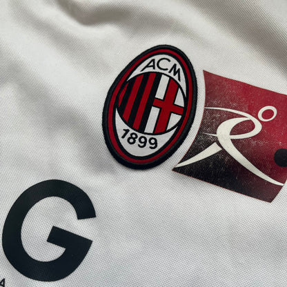AC Milan x Dolce &amp; Gabbana 2009/10 Training Tee is a white football shirt with red ended short sleeves. The chest features AC Milan and Adidas logos on the sides, and a D&amp;G Dolce &amp; Gabbana Junior logo in the center. Made with Climacool technology, it is designed for performance wear.
