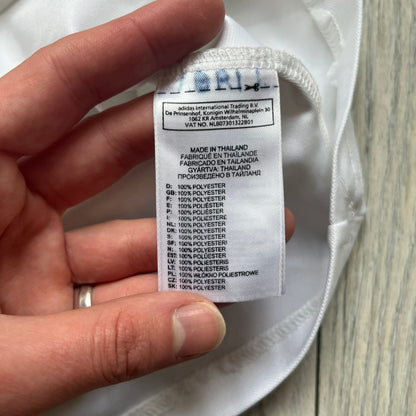 AC Milan x Dolce &amp; Gabbana 2009/10 Training Tee is a white football shirt with red ended short sleeves. The chest features AC Milan and Adidas logos on the sides, and a D&amp;G Dolce &amp; Gabbana Junior logo in the center. Made with Climalite technology, it is designed for performance wear.
