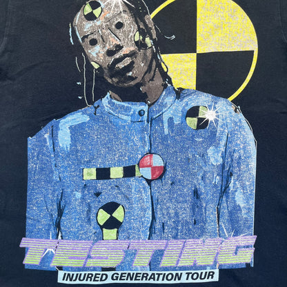 A$AP Rocky 2019 Injured Generation Tour “Crash Dummy” Tee is a black T-shirt released as part of the Injured Generation tour merchandise collection. The front features an illustrated crash dummy version of A$AP Rocky with “TESTING” text printed underneath. The opposite side includes a yellow and black burning TESTING logo graphic. Made in the USA.&nbsp;