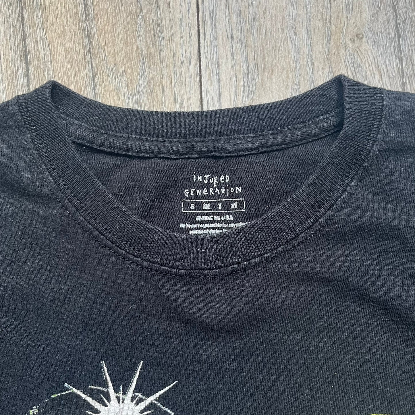 A$AP Rocky 2019 Injured Generation Tour “Crash Dummy” Tee is a black T-shirt released as part of the Injured Generation tour merchandise collection. The front features an illustrated crash dummy version of A$AP Rocky with “TESTING” text printed underneath. The opposite side includes a yellow and black burning TESTING logo graphic. Made in the USA.&nbsp;