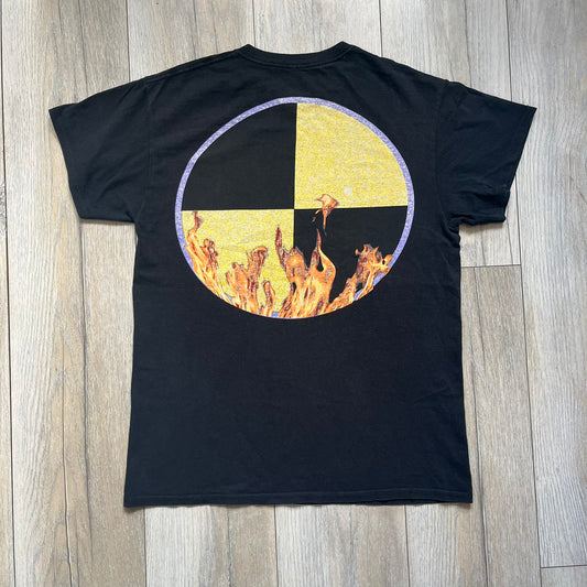A$AP Rocky 2019 Injured Generation Tour “Crash Dummy” Tee is a black T-shirt released as part of the Injured Generation tour merchandise collection. The front features an illustrated crash dummy version of A$AP Rocky with “TESTING” text printed underneath. The opposite side includes a yellow and black burning TESTING logo graphic. Made in the USA.&nbsp;
