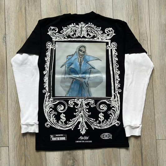 A$AP Rocky “Don’t Be Dumb” Mr Mayers Twofer Longsleeve is a limited release from the AWGE website tied to the rollout of Don’t Be Dumb by A$AP Rocky. The piece features a twofer construction with a black body and white sleeves, with a front graphic of the Mr Mayers figure in a blue trench coat with “Mr Mayers” text and small AWGE logos. The back includes a framed graphic with “Don’t Be Dumb” text, using a lenticular-style vinyl panel that shifts between the Mr Mayers figure and A$AP Rocky in the same outfit