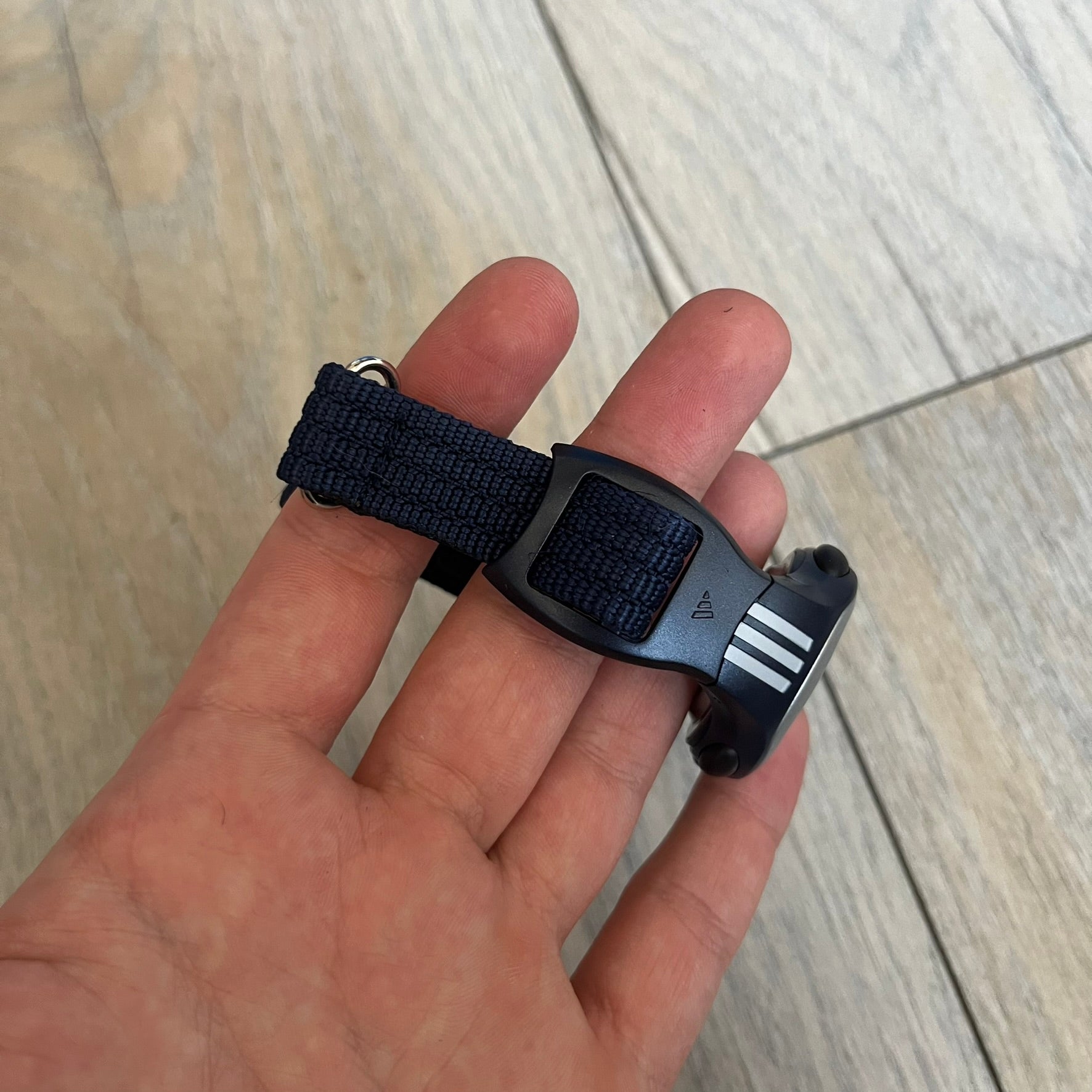 Adidas 2000s Navy 10-0117 Digital Watch (model X-003) is a navy digital watch with a silver bezel and ergonomic case. It features a navy nylon Velcro strap and four side buttons. The design includes three white stripes on the case and a silver Adidas logo button below the screen. The stainless steel back is engraved and marked water resistant up to 3 ATM, with an Adidas logo patch on the strap.