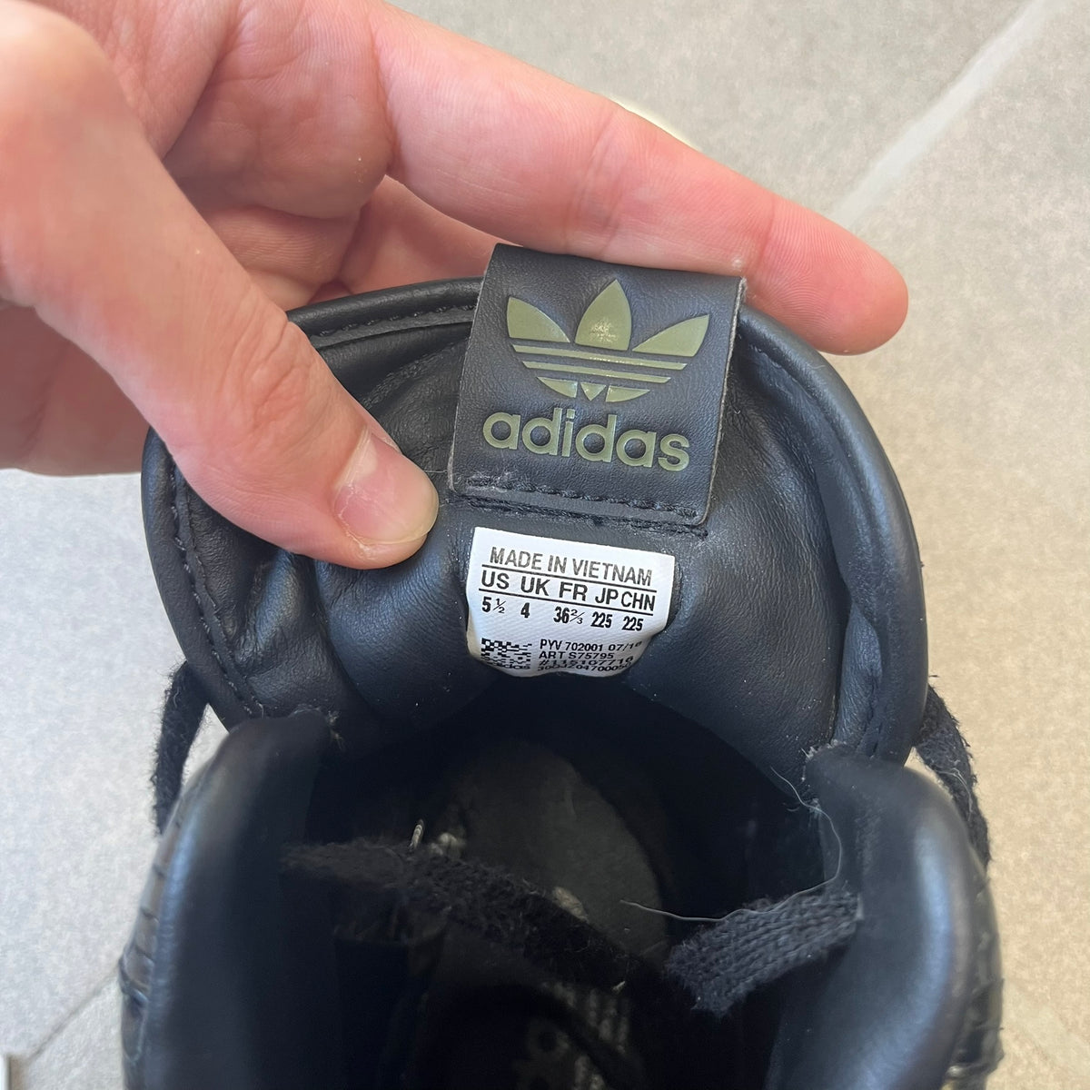 Adidas 2016 M Attitude Revive Snakeskin Sneakers are dark green sneakers covered in a shiny snakeskin-textured material, featuring black side stripes and a dark green Adidas Trefoil logo on the tongue. The sole is white with black accents.