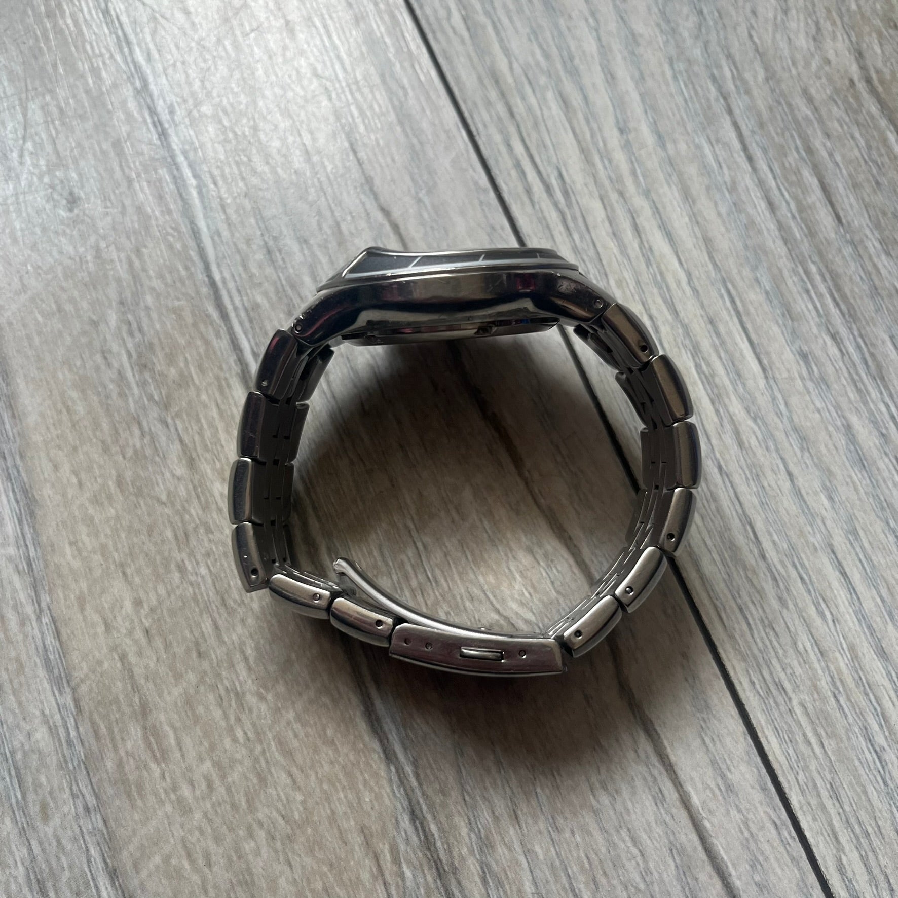 Adidas Adi-Star Pro Chrono ADP-1017 Analog Watch is a stainless steel timepiece with a white dial featuring the Adidas logo and three subdials for chronograph functions. It has two side buttons and a crown for adjustments, with a detailed and textured dial design. The watch is water resistant up to 200 meters.