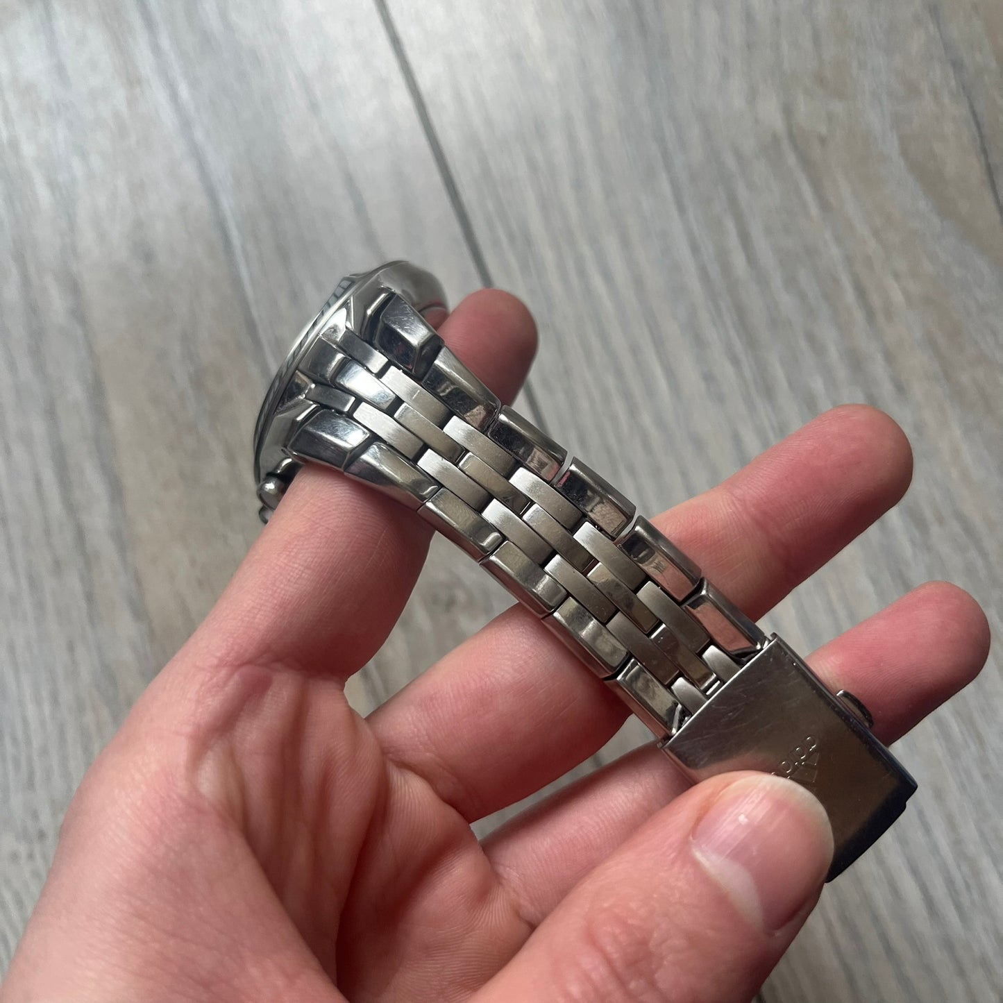 Adidas Adi-Star Pro Chrono ADP-1017 Analog Watch is a stainless steel timepiece with a white dial featuring the Adidas logo and three subdials for chronograph functions. It has two side buttons and a crown for adjustments, with a detailed and textured dial design. The watch is water resistant up to 200 meters.