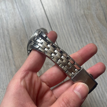 Adidas Adi-Star Pro Chrono ADP-1017 Analog Watch is a stainless steel timepiece with a white dial featuring the Adidas logo and three subdials for chronograph functions. It has two side buttons and a crown for adjustments, with a detailed and textured dial design. The watch is water resistant up to 200 meters.