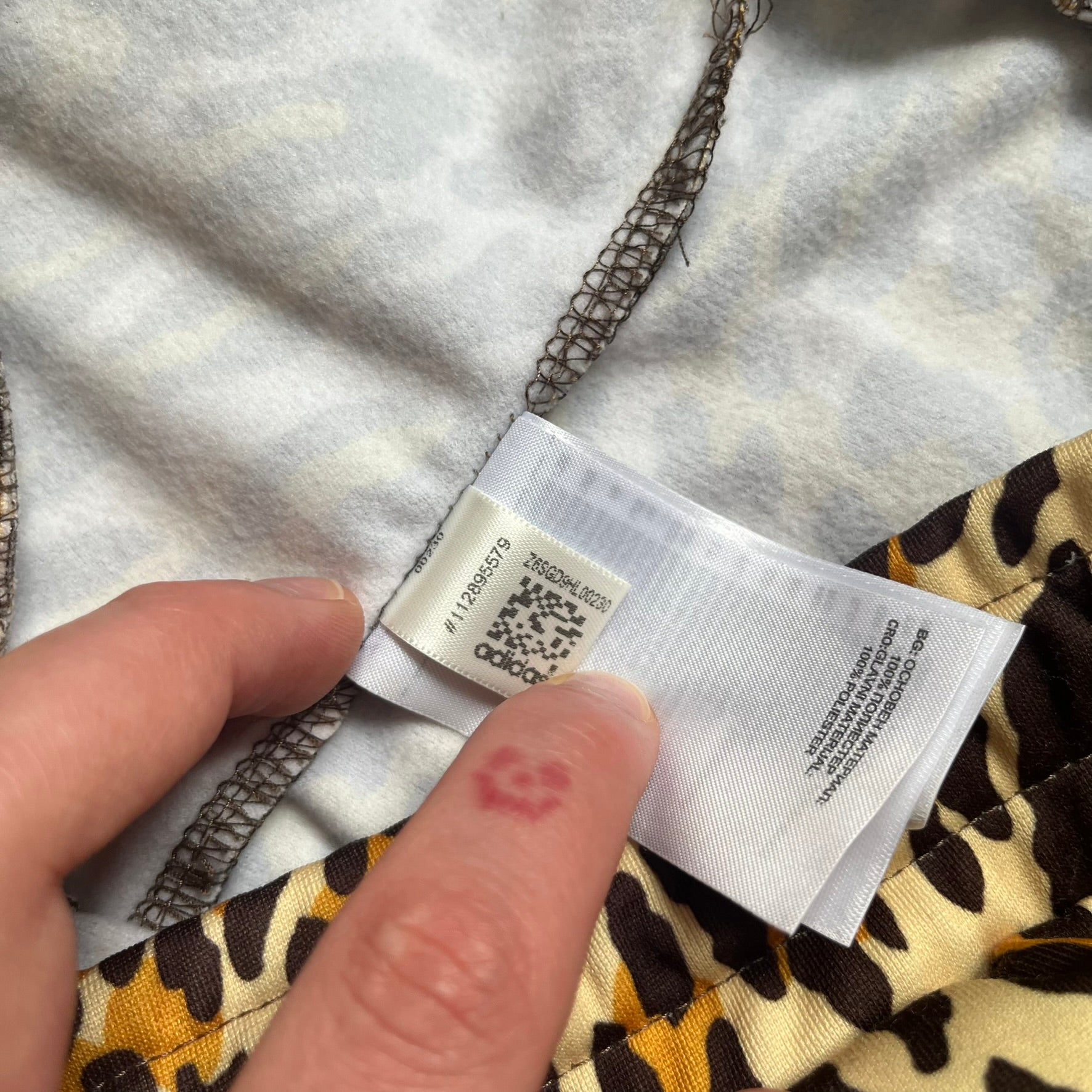 Adidas x Jeremy Scott 2015 Leopard Print Track Pants feature an all-over orange, brown, and white leopard print pattern throughout the garment. The design includes brown Adidas three-stripe detailing down both sides, zippered pockets, brown drawstrings, and an embroidered Adidas Trefoil logo. This pair was released as part of the Adidas Originals by Jeremy Scott collaboration.