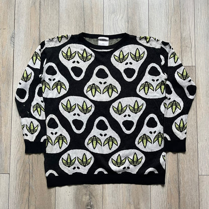 Adidas Jeremy Scott Alien Face 2012 Sweater features an all-over print of white alien faces arranged in alternating upright and upside-down patterns. The eyes of each alien are replaced with green Adidas Originals logos, creating a distinctive graphic design.