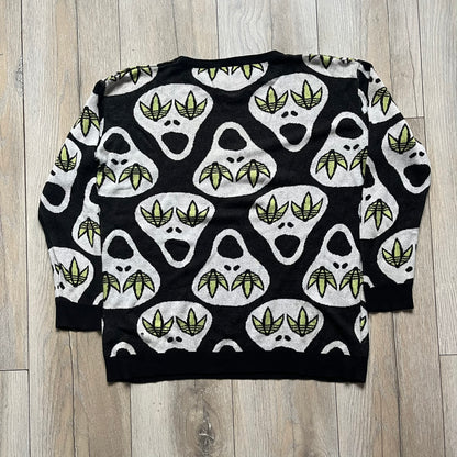 Adidas Jeremy Scott Alien Face 2012 Sweater features an all-over print of white alien faces arranged in alternating upright and upside-down patterns. The eyes of each alien are replaced with green Adidas Originals logos, creating a distinctive graphic design.