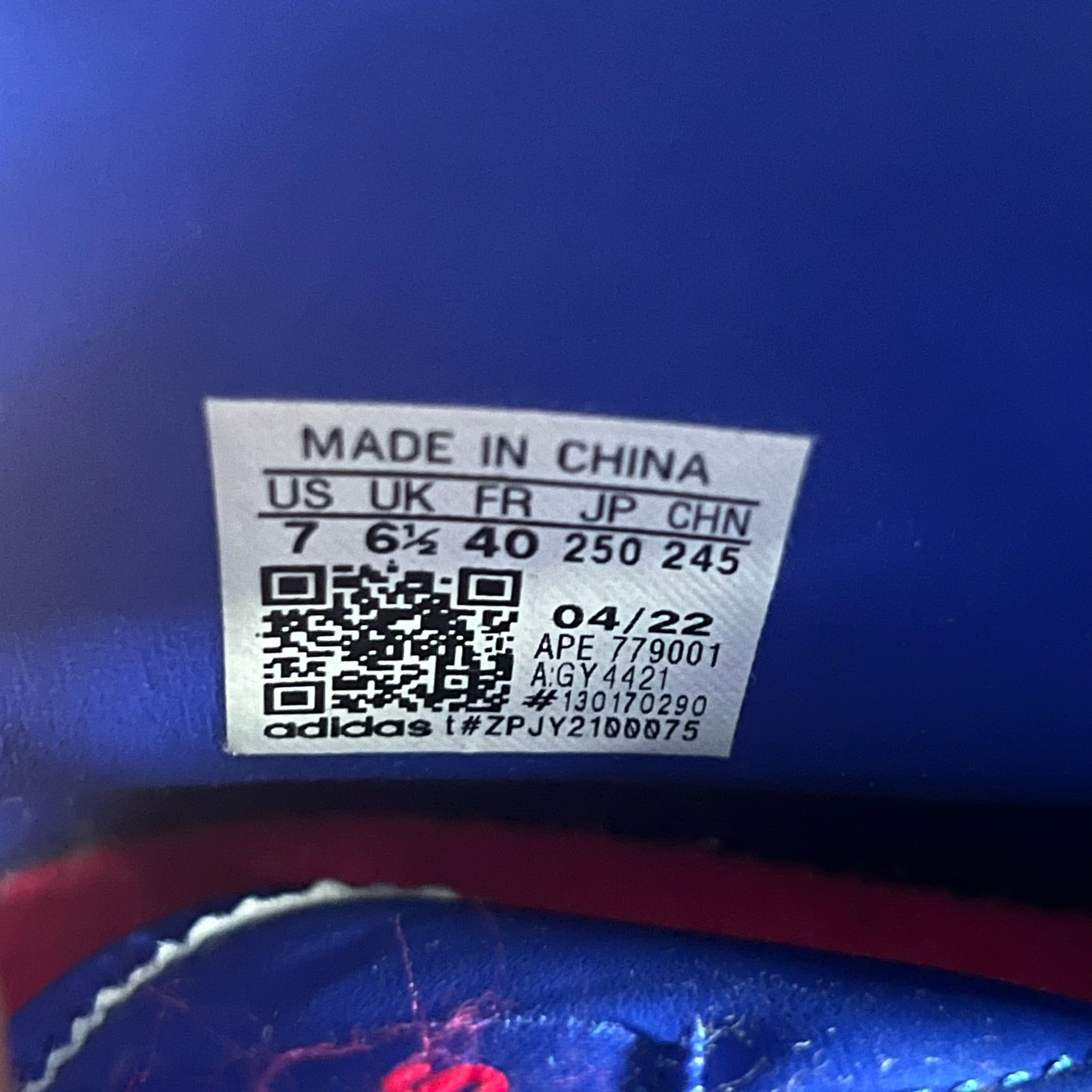 The Adidas Jeremy Scott Motorsport Wings 4.0 features a leather upper in blue with a gradient transitioning to green, accented by shock pink and light pink logo stripes. This high-top sneaker includes breathable perforations, a grippy rubber outsole, padded tongue, and signature Wings detailing at the collar. Released in 2022, the limited edition model comes with its original box and is crafted for comfort and style.