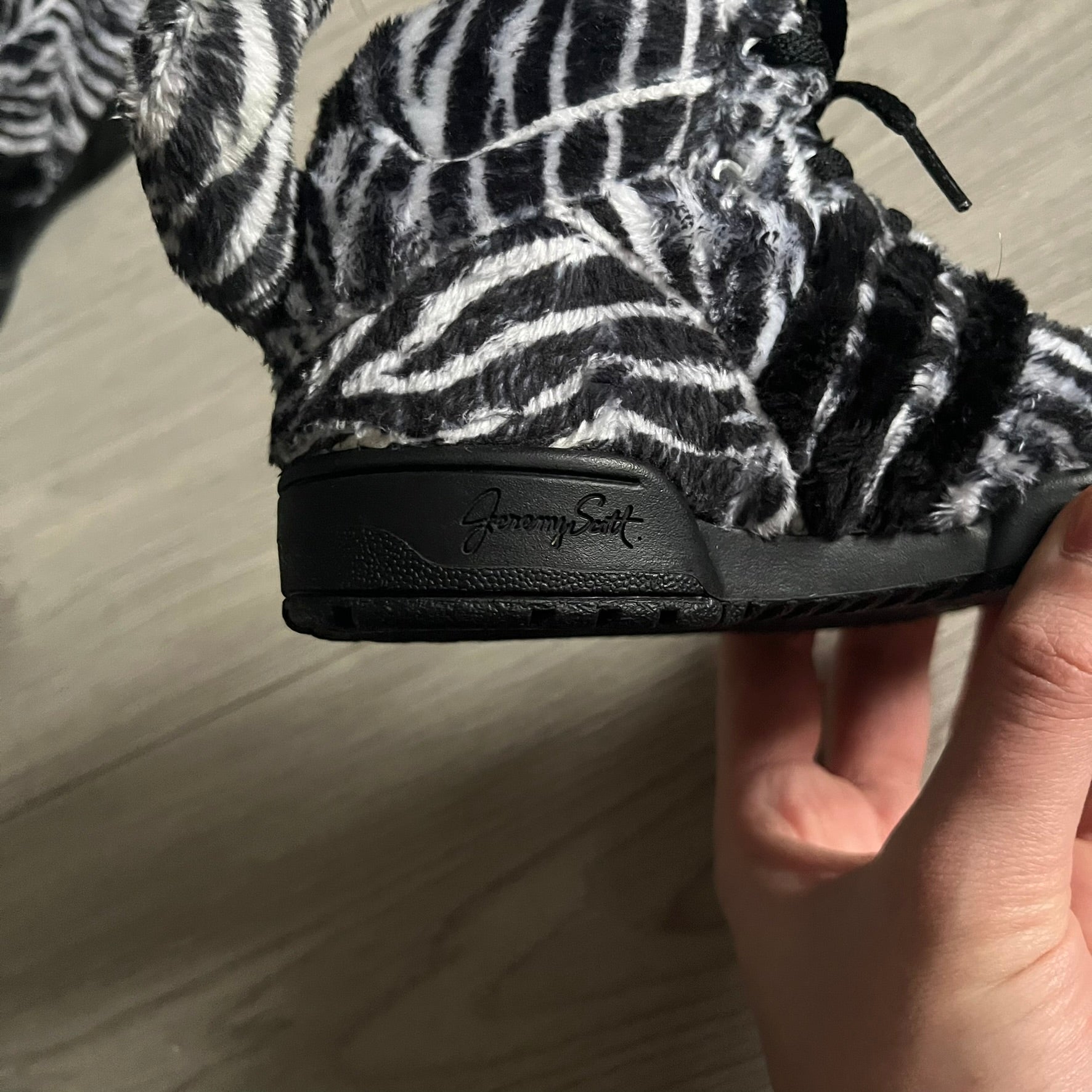 Adidas Jeremy Scott Zebra Black &amp; White Sneakers - Sample pair, Style G95749. High-top sneakers featuring black and white faux-fur zebra print, a 3D tail at the heel, rubber soles, and front lace closure. From the FW13 Jeremy Scott for Adidas collection, these iconic sneakers combine classic adidas design with signature crazy JS styling.