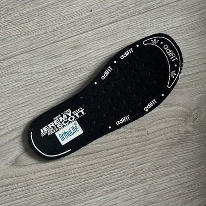 Adidas Jeremy Scott Zebra Black &amp; White Sneakers - Sample pair, Style G95749. High-top sneakers featuring black and white faux-fur zebra print, a 3D tail at the heel, rubber soles, and front lace closure. From the FW13 Jeremy Scott for Adidas collection, these iconic sneakers combine classic adidas design with signature crazy JS styling.