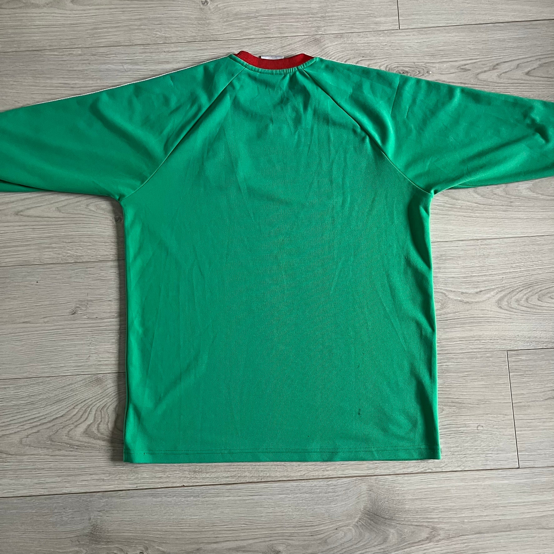 Adidas 2007-08 Mexico Powerade Limited Edition 3/4 Tee in green with red collar and white Adidas sleeve stripes. Features embroidered Adidas logo beneath the neck, Mexico crest on the heart, and a “Powerade Edición Especial” patch at the lower front. Extremely rare, issued only to select Coca-Cola store owners in Mexico.