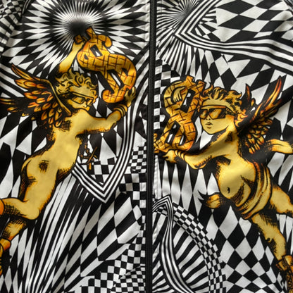 Gold cherub with wings on a black and white geometric patterned background