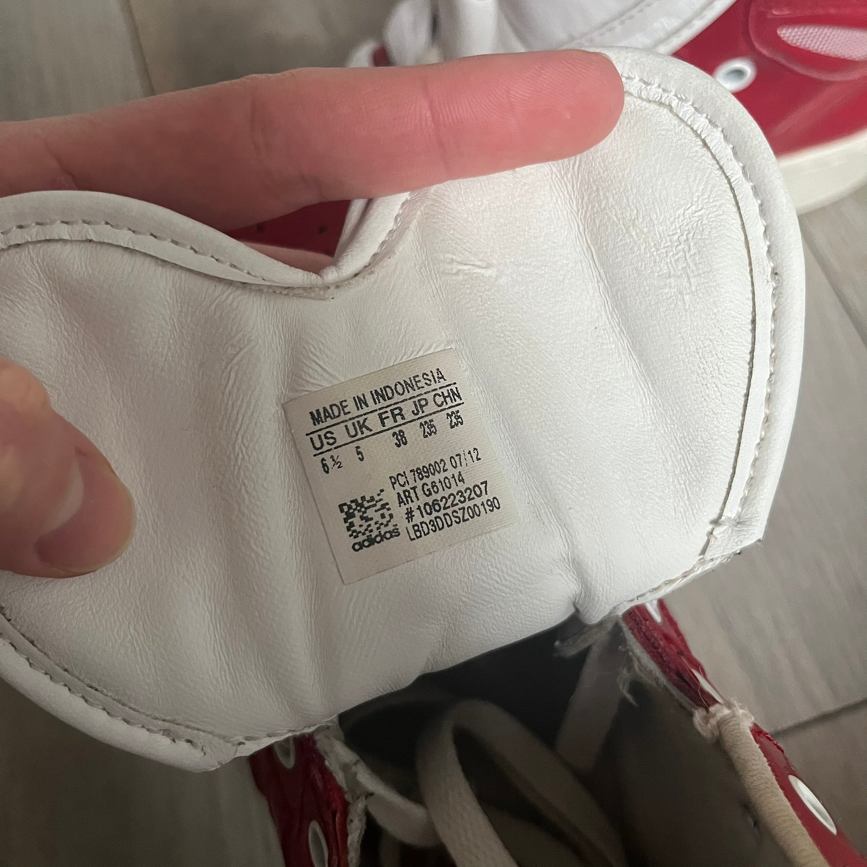 Adidas Originals Metro Attitude Logo Heart Sneakers are women’s sneakers released in 2012, featuring a red suede upper with matching University-Red accents. The design includes dual heart-shaped tongues in white with red Adidas logos, paired with a white sole and laces. Metro Attitude Logo Heart W model (G61014) inspired by Jeremy Scott collaborations.