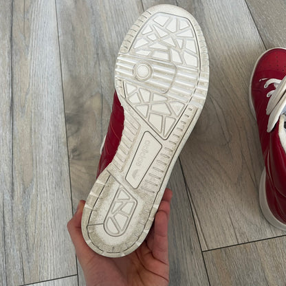 Adidas Originals Metro Attitude Logo Heart Sneakers are women’s sneakers released in 2012, featuring a red suede upper with matching University-Red accents. The design includes dual heart-shaped tongues in white with red Adidas logos, paired with a white sole and laces. Metro Attitude Logo Heart W model (G61014) inspired by Jeremy Scott collaborations