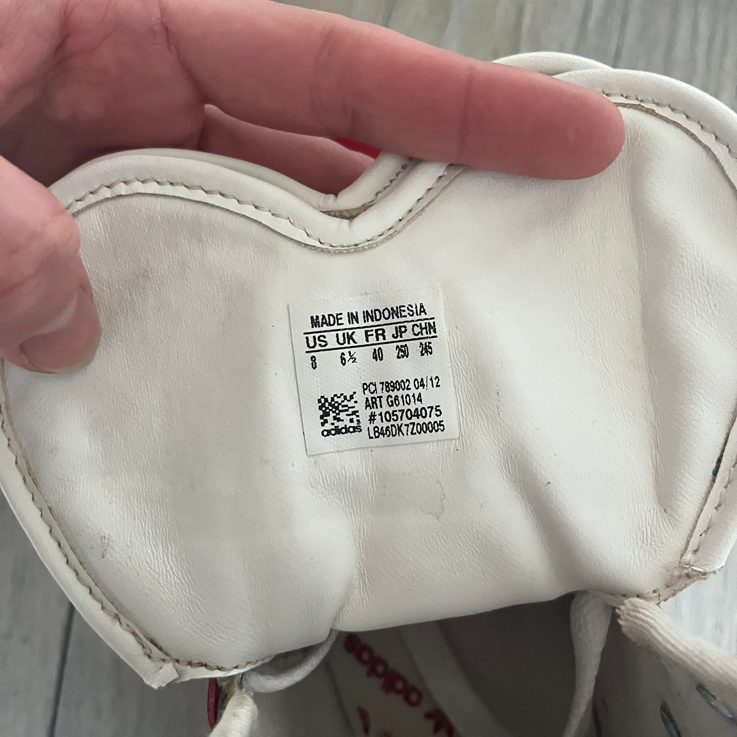 Adidas Originals Metro Attitude Logo Heart Sneakers are women’s sneakers released in 2012, featuring a red suede upper with matching University-Red accents. The design includes dual heart-shaped tongues in white with red Adidas logos, paired with a white sole and laces. Metro Attitude Logo Heart W model (G61014) inspired by Jeremy Scott collaborations.