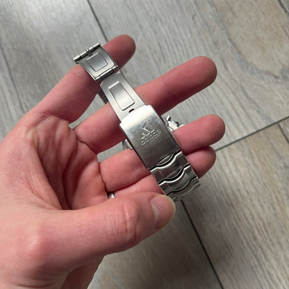 Adidas VS Chronograph 10-5010 Analog Watch is a silver-tone metal timepiece featuring a metallic blue dial with day and seconds indicators. The watch includes three sub-dials, a detailed seconds track, and three side buttons for chronograph functions. Designed with a sturdy, thick case, it comes with an extra link for adjustable sizing.