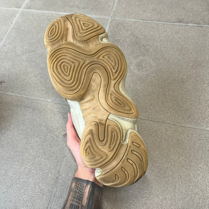 Adidas Yeezy 500 “Stone” Sneakers feature a Stone/Stone/Stone colorway with suede and neoprene paneling, reflective piping, and a pull-tab at the tongue. The sneakers have a lace-up fastening, adiPRENE midsole, and gum rubber outsole. Style FW4839, released November 23, 2019.
