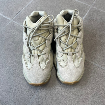 Adidas Yeezy 500 “Stone” Sneakers feature a Stone/Stone/Stone colorway with suede and neoprene paneling, reflective piping, and a pull-tab at the tongue. The sneakers have a lace-up fastening, adiPRENE midsole, and gum rubber outsole. Style FW4839, released November 23, 2019.
