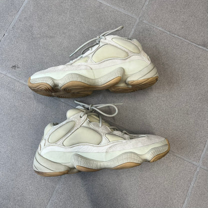 Adidas Yeezy 500 “Stone” Sneakers feature a Stone/Stone/Stone colorway with suede and neoprene paneling, reflective piping, and a pull-tab at the tongue. The sneakers have a lace-up fastening, adiPRENE midsole, and gum rubber outsole. Style FW4839, released November 23, 2019.
