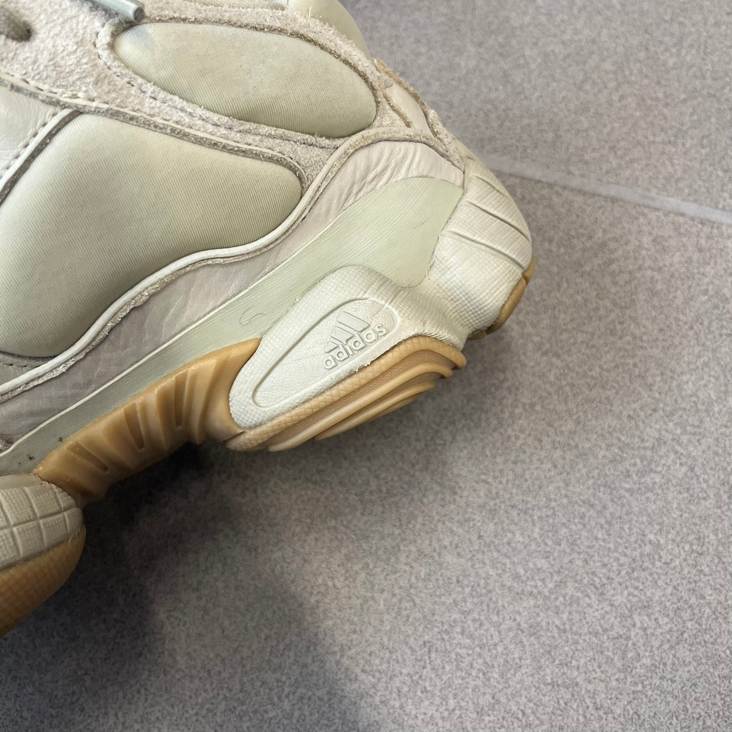 Adidas Yeezy 500 “Stone” Sneakers feature a Stone/Stone/Stone colorway with suede and neoprene paneling, reflective piping, and a pull-tab at the tongue. The sneakers have a lace-up fastening, adiPRENE midsole, and gum rubber outsole. Style FW4839, released November 23, 2019.
