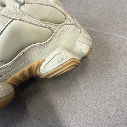 Adidas Yeezy 500 “Stone” Sneakers feature a Stone/Stone/Stone colorway with suede and neoprene paneling, reflective piping, and a pull-tab at the tongue. The sneakers have a lace-up fastening, adiPRENE midsole, and gum rubber outsole. Style FW4839, released November 23, 2019.
