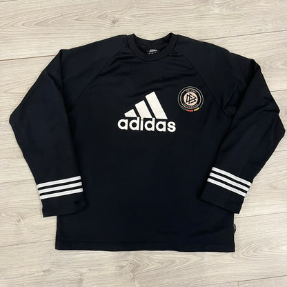 Adidas 2004/05 Germany Longsleeve in black featuring the Talent Förderung logo on the front and a center Adidas chest logo. Designed with classic three white stripes along the wrists and multiple sponsor logos on the back, including Mercedes, Adidas, and Nintendo. Made with Climawear fabric for comfort and performance.
