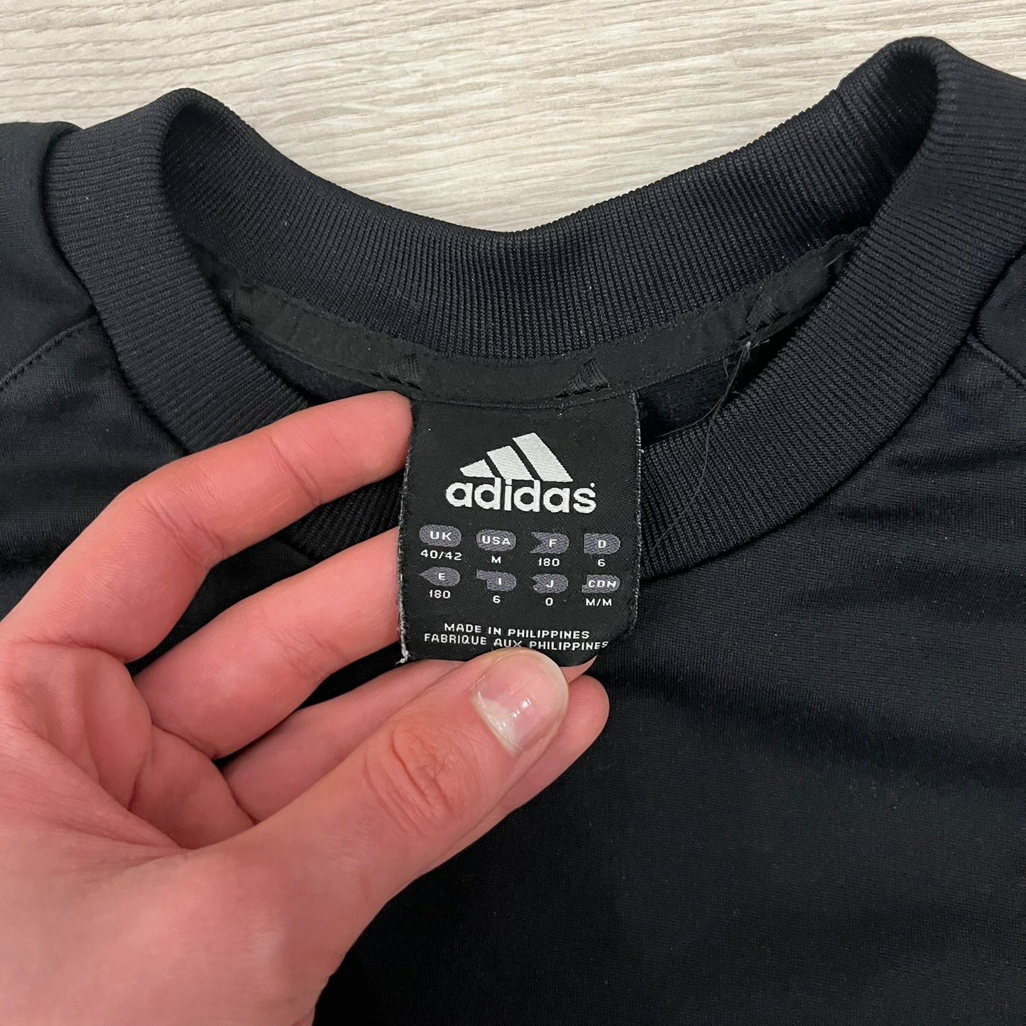 Adidas 2004/05 Germany Longsleeve in black featuring the Talent Förderung logo on the front and a center Adidas chest logo. Designed with classic three white stripes along the wrists and multiple sponsor logos on the back, including Mercedes, Adidas, and Nintendo. Made with Climawear fabric for comfort and performance.