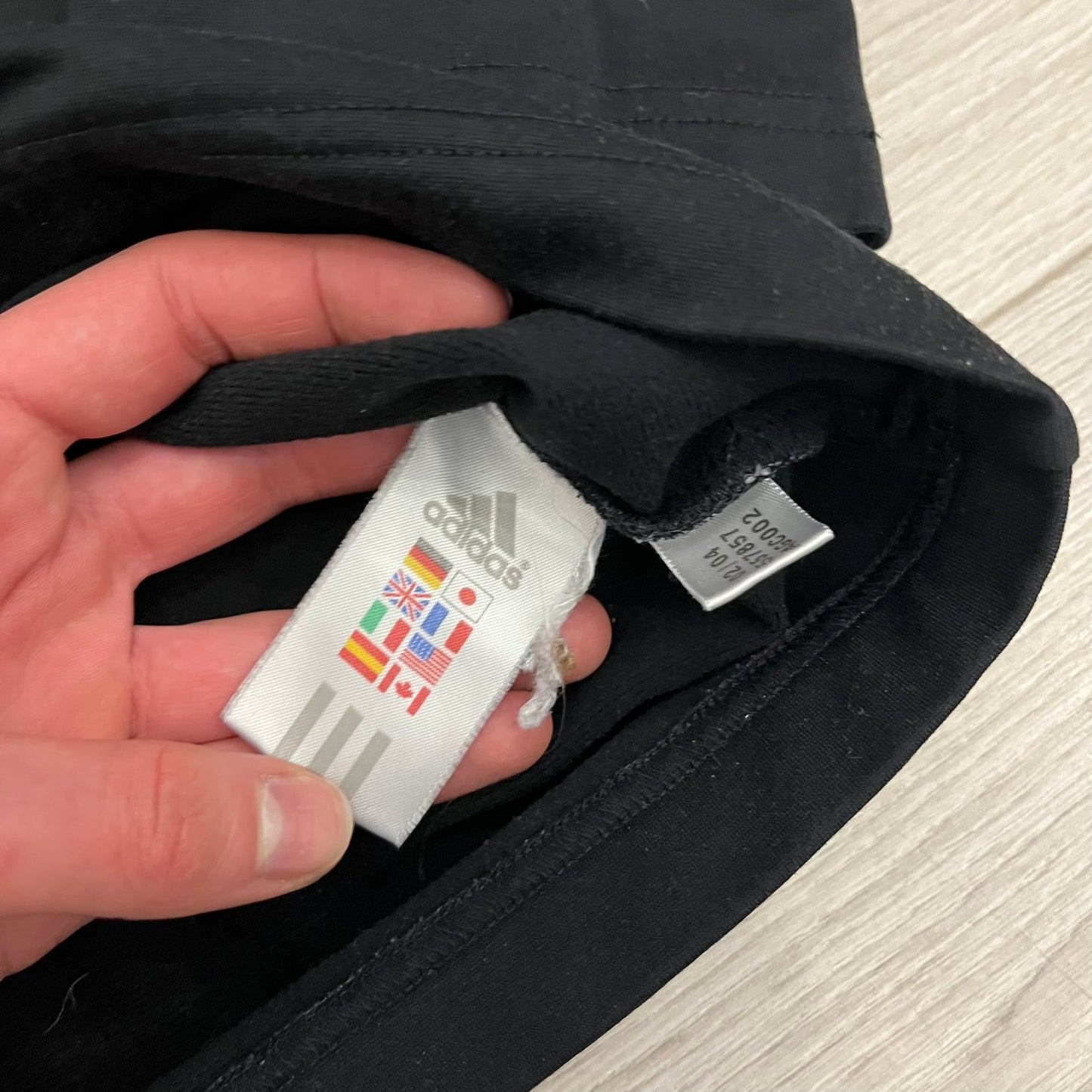 Adidas 2004/05 Germany Longsleeve in black featuring the Talent Förderung logo on the front and a center Adidas chest logo. Designed with classic three white stripes along the wrists and multiple sponsor logos on the back, including Mercedes, Adidas, and Nintendo. Made with Climawear fabric for comfort and performance.