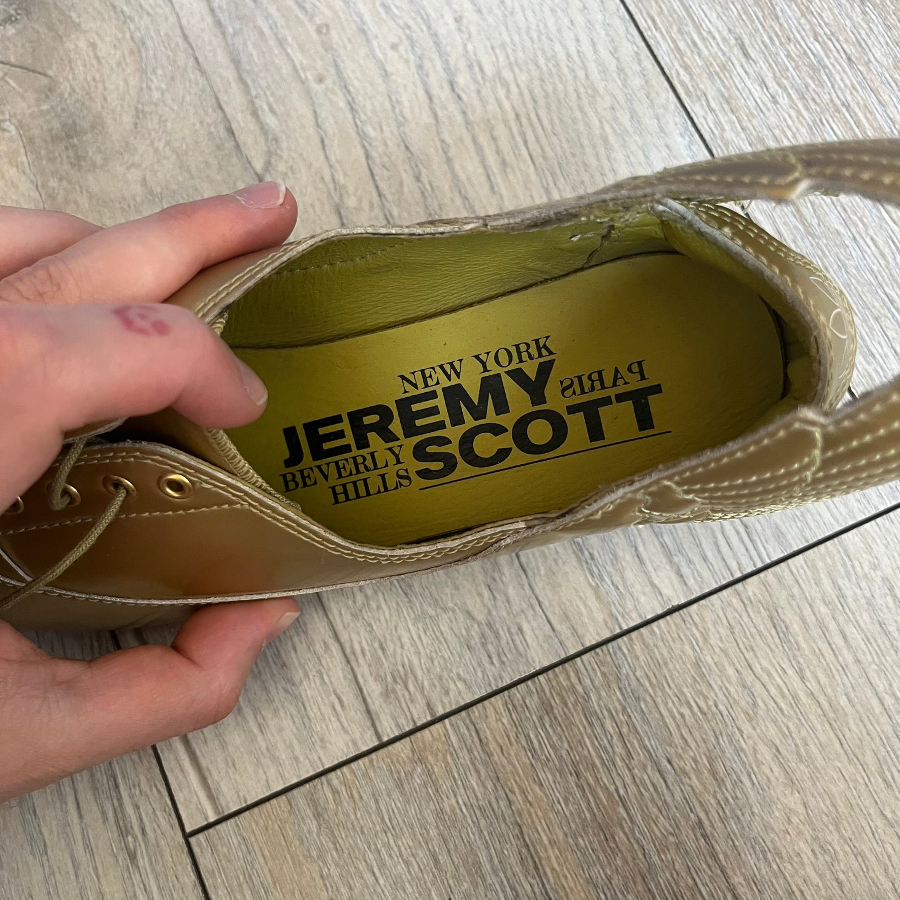 Adidas x Jeremy Scott 2011 Wings Gold Ballet Flats are a rare footwear design combining a classic ballet flat silhouette with Jeremy Scott’s signature wing motif. The shoes feature a fully metallic gold finish with visible stitching throughout the upper and wing construction. Small 3D wings extend from both sides of the heel area, creating the iconic Wings look in a streamlined form. Finished with a Trefoil Adidas logo on the back.