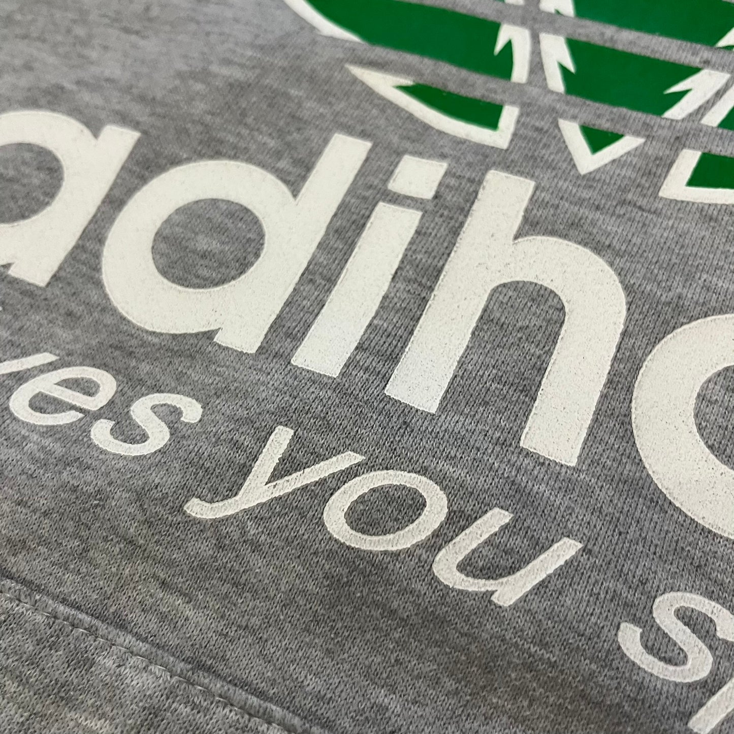 This Adihash “Gives You Speed!” Hoodie features a playful twist on the classic adidas emblem, replacing the trefoil with three marijuana leaves and big Adihash branding. Made from a soft polyester–cotton blend, it offers everyday comfort with a standard pouch pocket and a clean grey finish. Produced on a Lemon Collection blank.