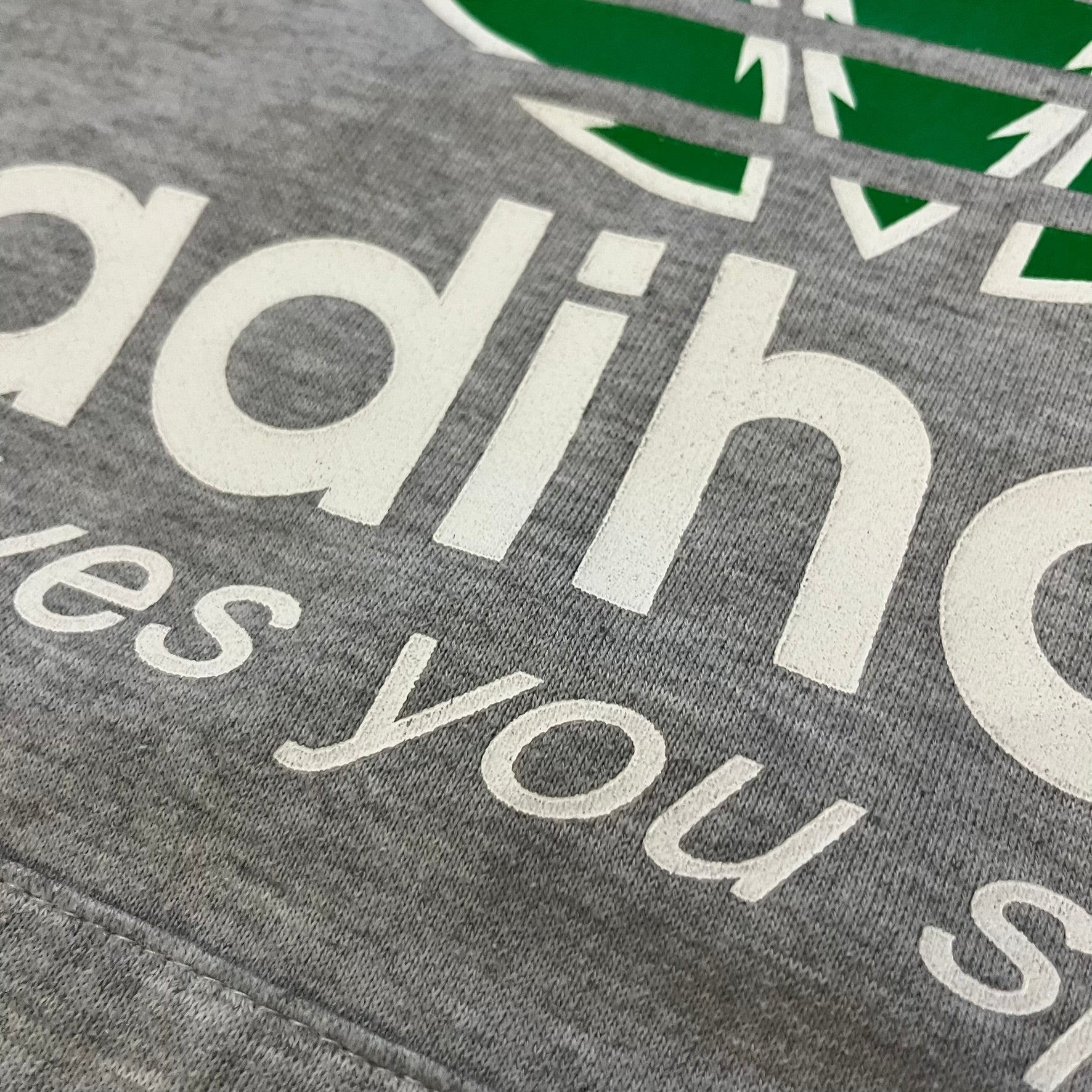 This Adihash “Gives You Speed!” Hoodie features a playful twist on the classic adidas emblem, replacing the trefoil with three marijuana leaves and big Adihash branding. Made from a soft polyester–cotton blend, it offers everyday comfort with a standard pouch pocket and a clean grey finish. Produced on a Lemon Collection blank.