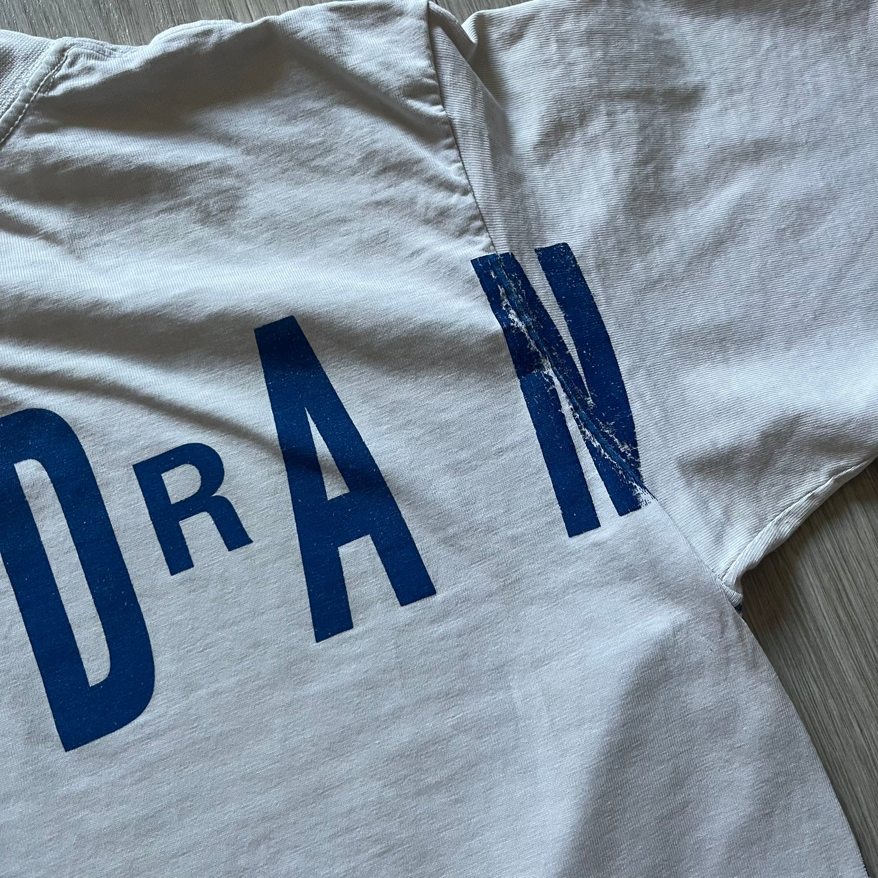 Air Jordan 2000’s All Over Print Tee featuring a bold full print of Michael Jordan in black, white, and blue across the front. A small red Jumpman logo sits at the bottom, while the back showcases a large Air Jordan logo with embroidered small red logo just under the collar. A rare vintage piece from the 2000s that captures peak Jordan era style.