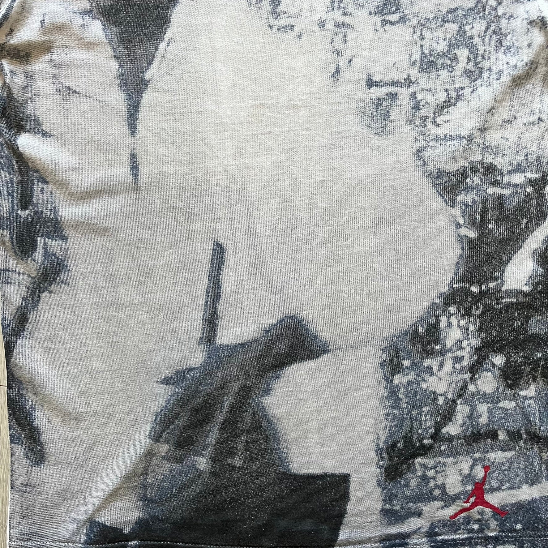 Air Jordan 2000’s All Over Print Tee featuring a bold full print of Michael Jordan in black, white, and blue across the front. A small red Jumpman logo sits at the bottom, while the back showcases a large Air Jordan logo with embroidered small red logo just under the collar. A rare vintage piece from the 2000s that captures peak Jordan era style.