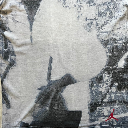 Air Jordan 2000’s All Over Print Tee featuring a bold full print of Michael Jordan in black, white, and blue across the front. A small red Jumpman logo sits at the bottom, while the back showcases a large Air Jordan logo with embroidered small red logo just under the collar. A rare vintage piece from the 2000s that captures peak Jordan era style.