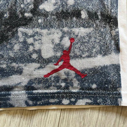 Air Jordan 2000’s All Over Print Tee featuring a bold full print of Michael Jordan in black, white, and blue across the front. A small red Jumpman logo sits at the bottom, while the back showcases a large Air Jordan logo with embroidered small red logo just under the collar. A rare vintage piece from the 2000s that captures peak Jordan era style.