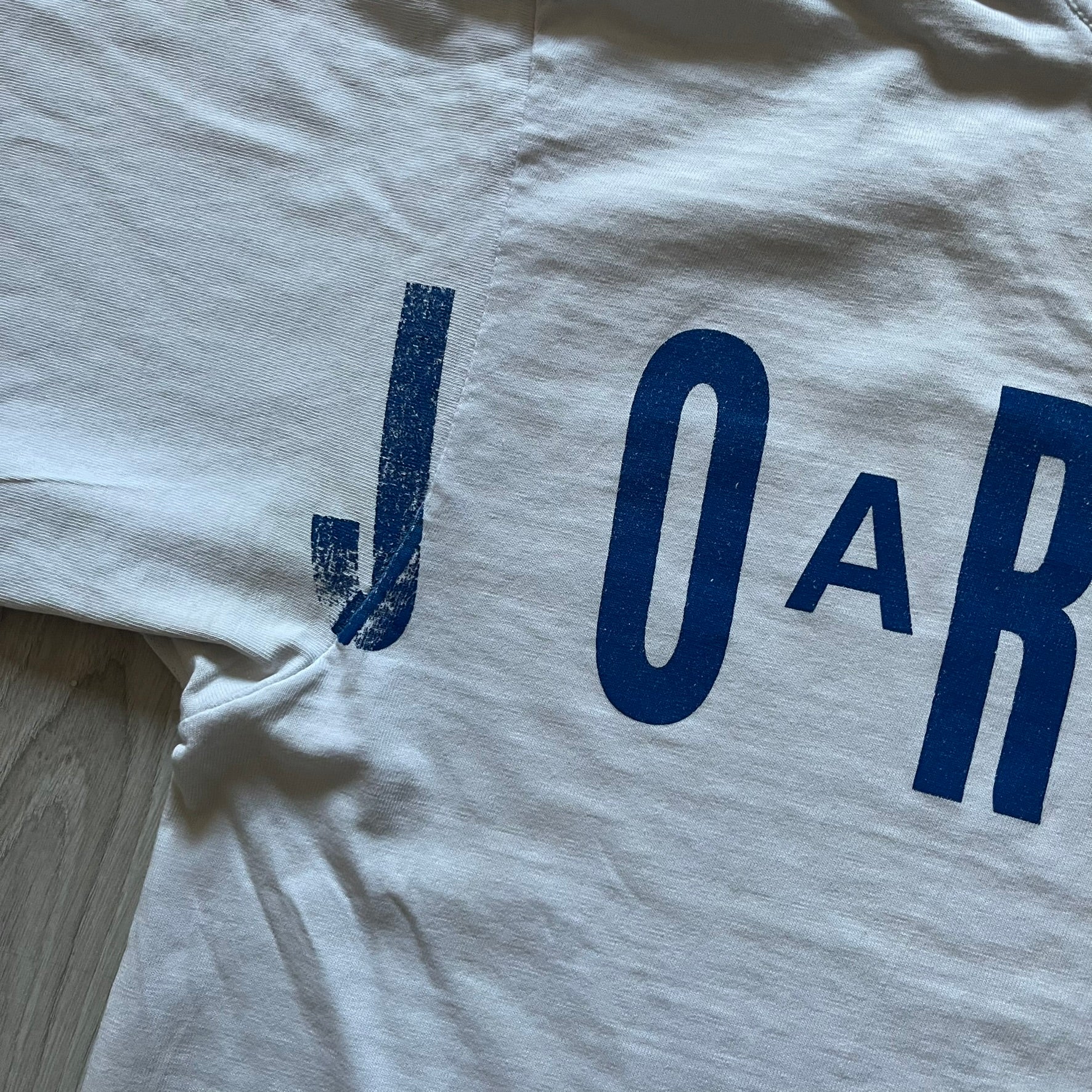 Air Jordan 2000’s All Over Print Tee featuring a bold full print of Michael Jordan in black, white, and blue across the front. A small red Jumpman logo sits at the bottom, while the back showcases a large Air Jordan logo with embroidered small red logo just under the collar. A rare vintage piece from the 2000s that captures peak Jordan era style.