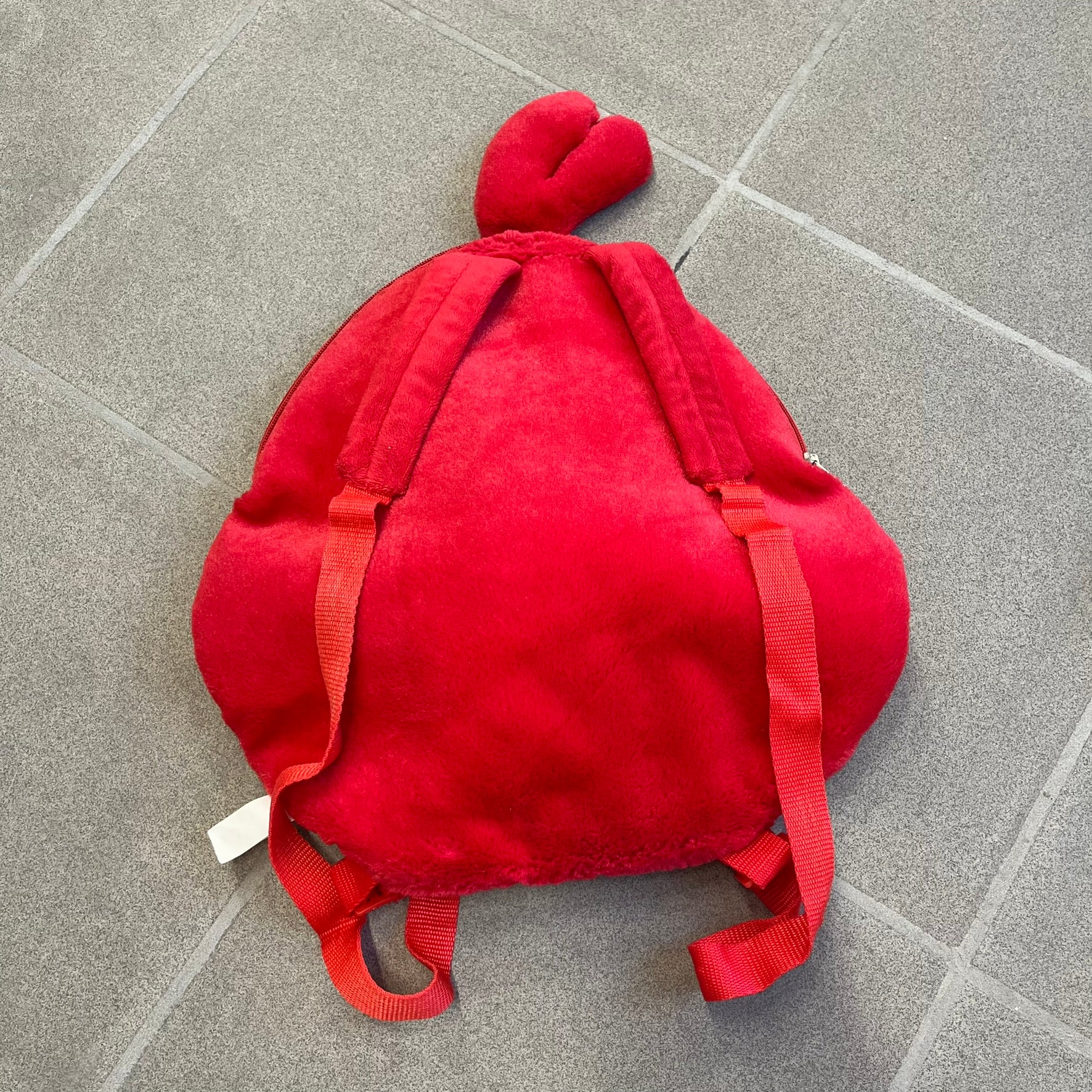 Angry Birds 2010s Red Bird Backpack is a small backpack shaped like Red, the iconic Angry Birds character. It features an angry facial expression with a three-dimensional beak and feather details, along with adjustable red shoulder straps. The interior includes official Angry Birds 2011 licensing.
