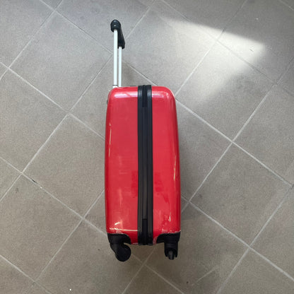 Angry Birds 2010s Red Bird Suitcase is a red rolling suitcase featuring the face of Red, the iconic Angry Birds character, on the front. It includes black wheels, a silver and black retractable handle, and an Angry Birds logo on the back. The interior features adjustable straps, zipped mesh compartments, and an all-over monogram lining with Angry Birds character patterns.
