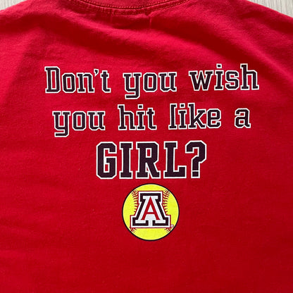 Red t-shirt with text 'Don't you wish you hit like a GIRL?' and a softball graphic on a plain background