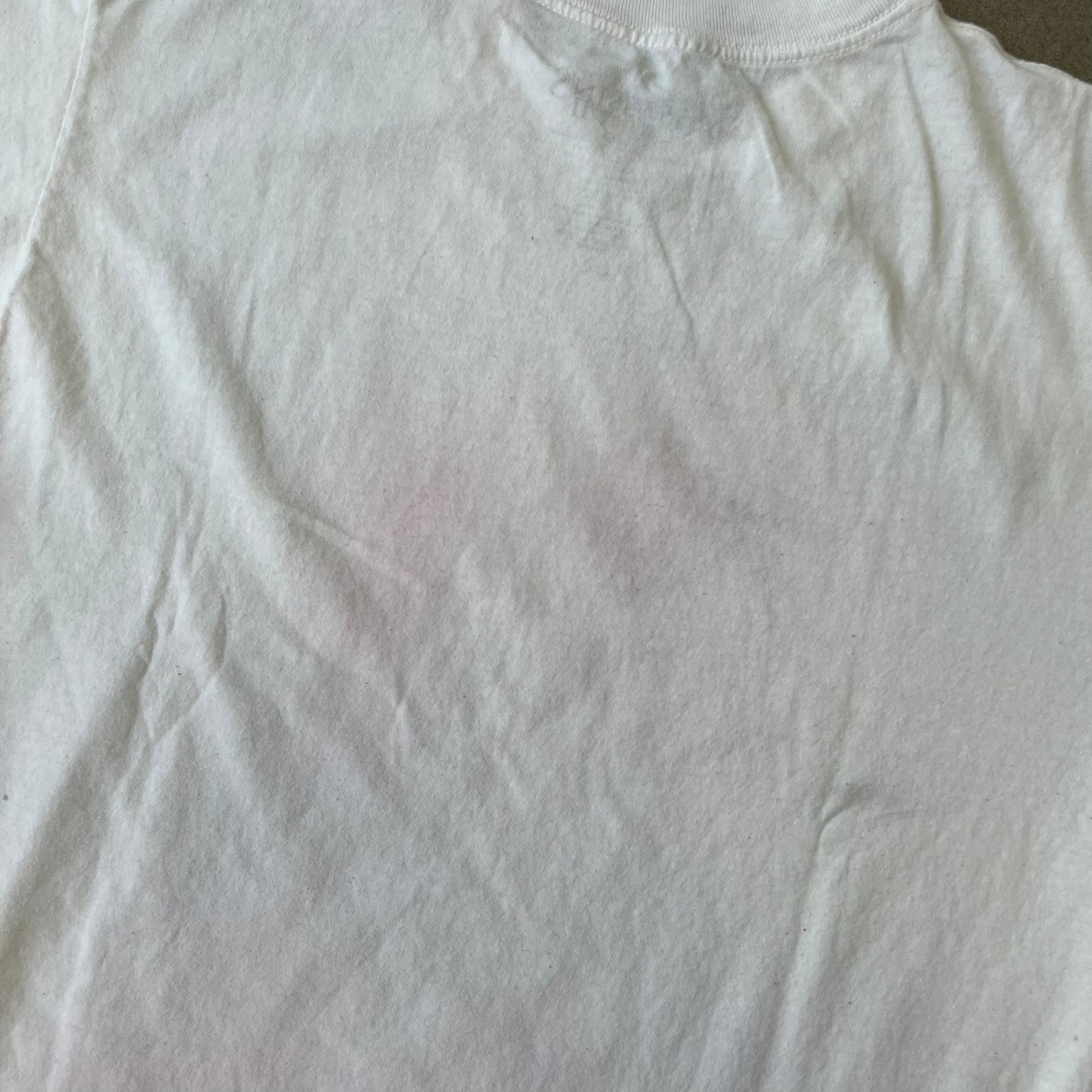 Assassin's Creed 2 Promo 2010 White Tee features a white 100% cotton construction with a large colorful graphic of Ezio Auditore da Firenze on the front. The Assassin's Creed 2 logo appears underneath the character, finished with a licensed neck tag.
