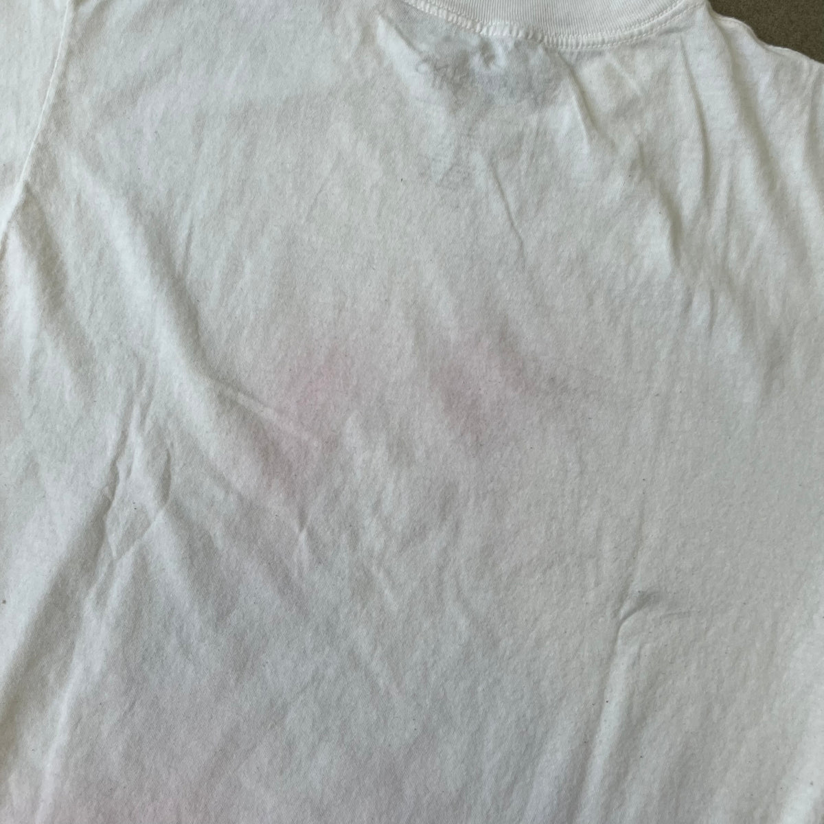 Assassin's Creed 2 Promo 2010 White Tee features a white 100% cotton construction with a large colorful graphic of Ezio Auditore da Firenze on the front. The Assassin's Creed 2 logo appears underneath the character, finished with a licensed neck tag.
