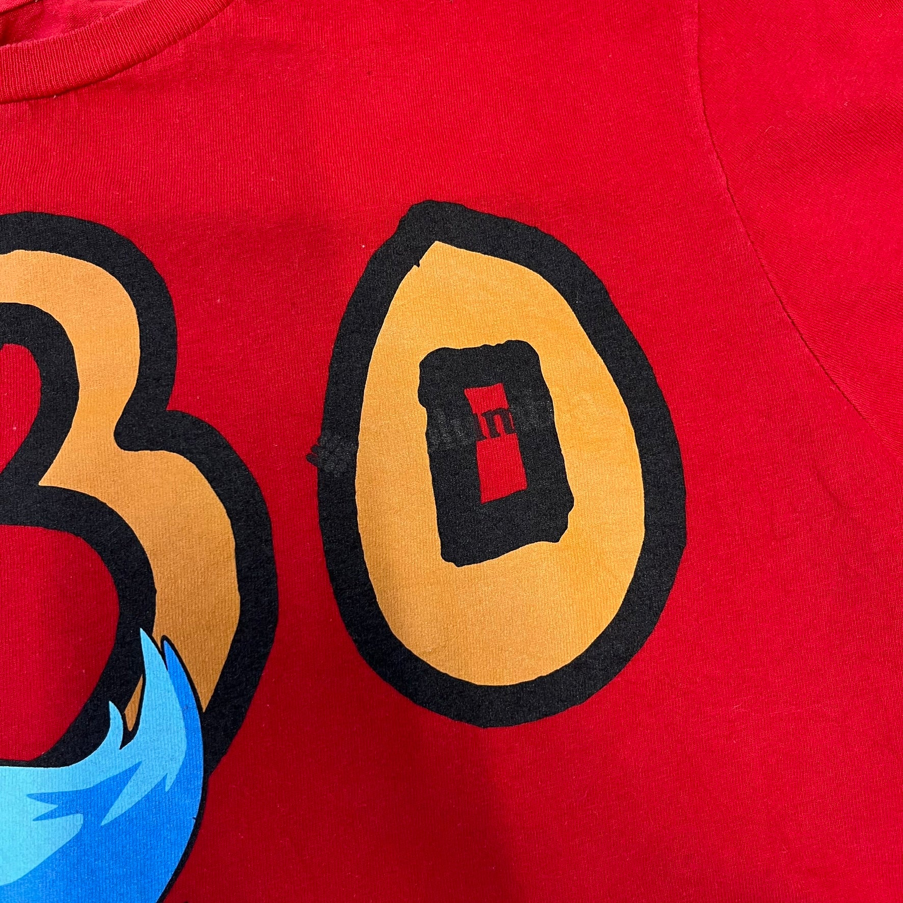 Asspizza 2024 Shiny Ponyta Red Tee is a red T-shirt featuring a shiny Ponyta graphic on the front with a yellow “730” number printed above. Next to the Ponyta graphic is a small black “Babbitt 2024 #077” text detail. The shirt is printed on a Colombia blank.

