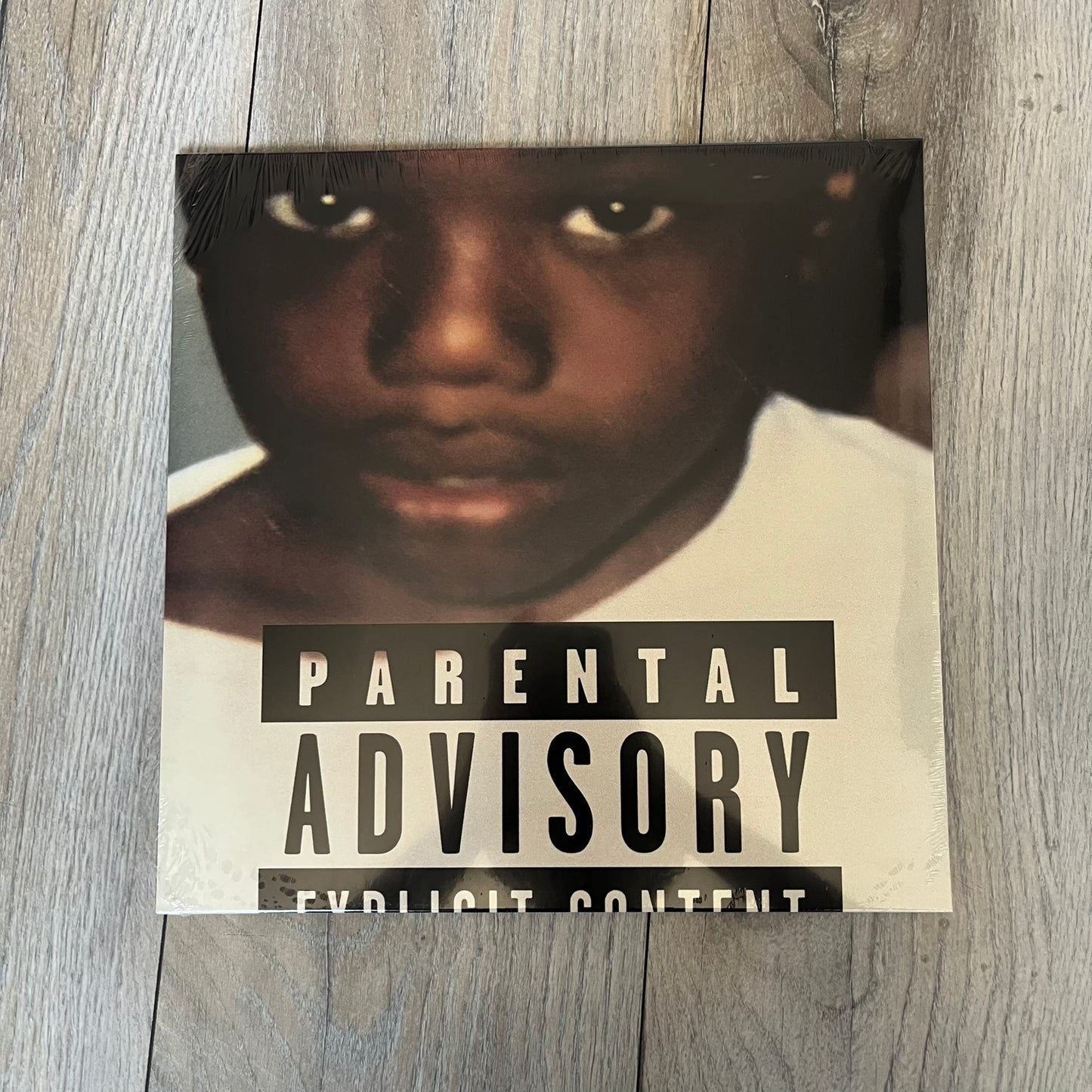 Baby Keem “Ca$ino” Exclusive Vinyl is a first print release from February 20, 2026, issued under pgLang (C-389572). The record includes an exclusive track “Tubi,” with additional audio differences such as extended talking on track A1 and an intro clip on track A5 not present on digital versions. The cover features Baby Keem on the front with a large “Parental Advisory” label, while the back displays two dice showing double twos.