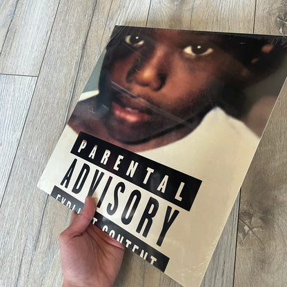 Baby Keem “Ca$ino” Exclusive Vinyl is a first print release from February 20, 2026, issued under pgLang (C-389572). The record includes an exclusive track “Tubi,” with additional audio differences such as extended talking on track A1 and an intro clip on track A5 not present on digital versions. The cover features Baby Keem on the front with a large “Parental Advisory” label, while the back displays two dice showing double twos.