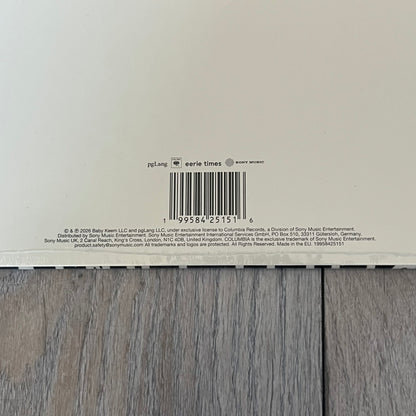 Baby Keem “Ca$ino” Exclusive Vinyl is a first print release from February 20, 2026, issued under pgLang (C-389572). The record includes an exclusive track “Tubi,” with additional audio differences such as extended talking on track A1 and an intro clip on track A5 not present on digital versions. The cover features Baby Keem on the front with a large “Parental Advisory” label, while the back displays two dice showing double twos.